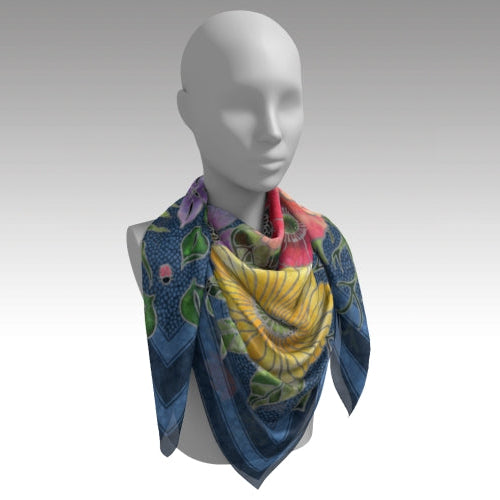 Mannequin wearing a colorful patterned scarf on a plain background