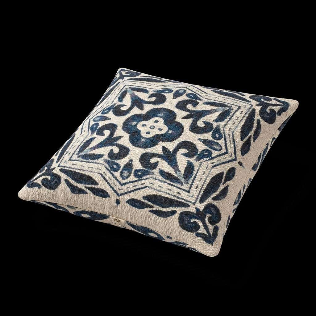 Decorative pillow with blue floral pattern on a black background