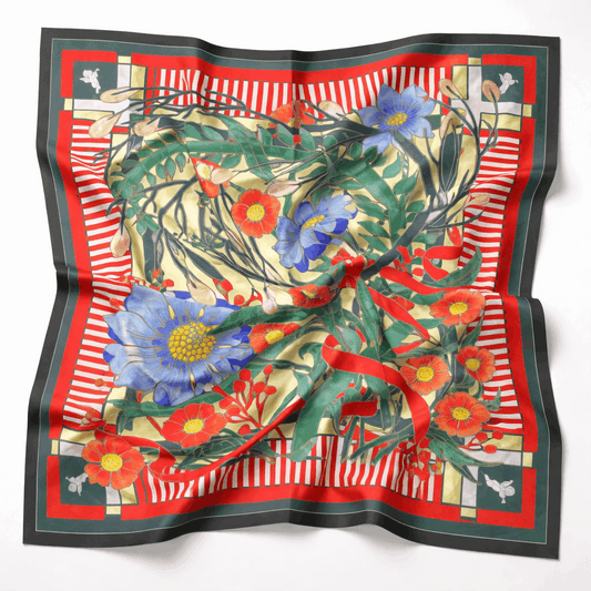 Floral patterned scarf with red border on a white background