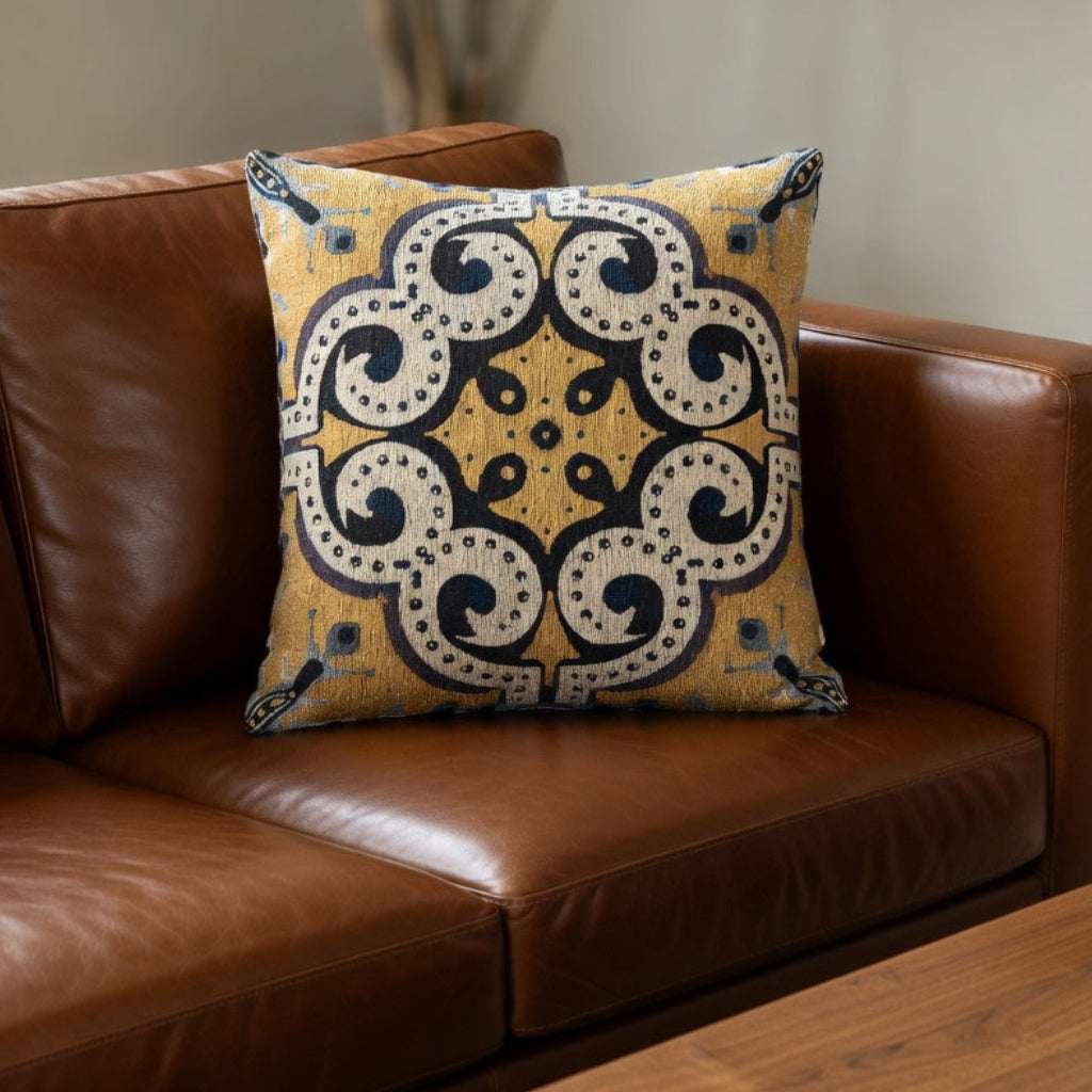 Decorative pillow on a brown leather sofa with a blurred background