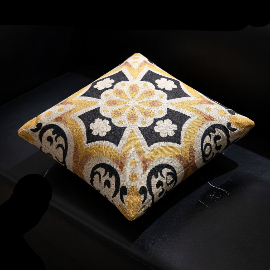 Decorative pillow with geometric pattern on a black surface
